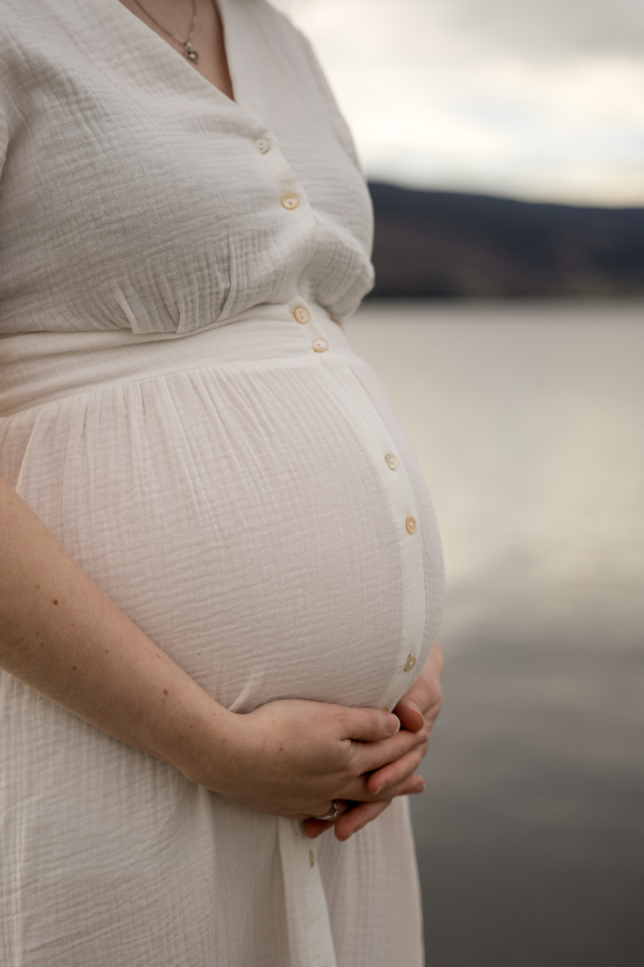 Close-up of Pregnant Woman Holding Her Belly Outdoors